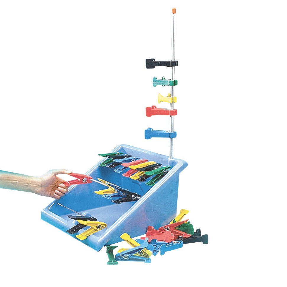 A blue tray holds multicolored Replacement Pins for Finger Pinch Exerciser, with some scattered outside and a hand holding one.