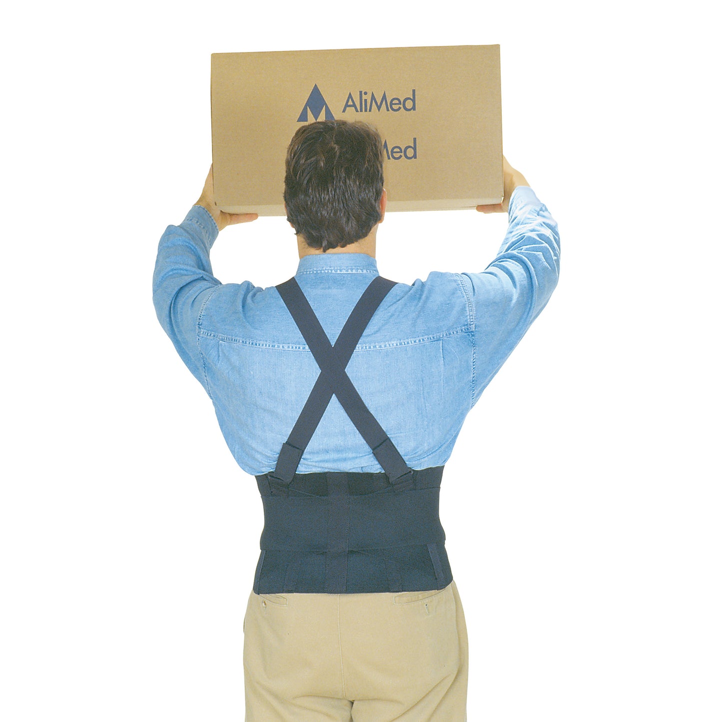 Person wearing an AliMed Elastic Brace lifts a large box above their head. They are in a blue shirt and beige pants.