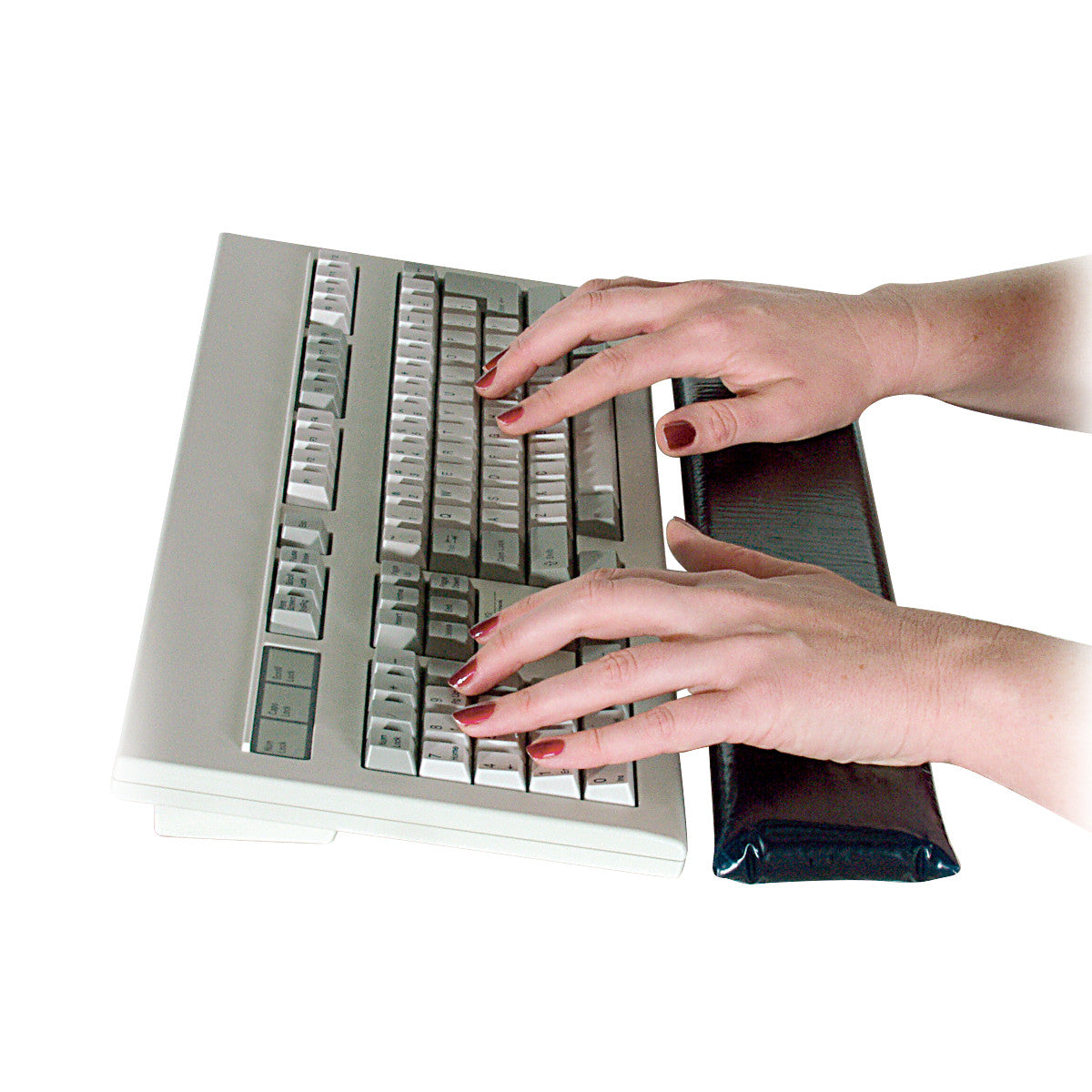 Hands typing on a keyboard using an AliMed Cleanable Wrist Support, positioned in front of the keyboard.