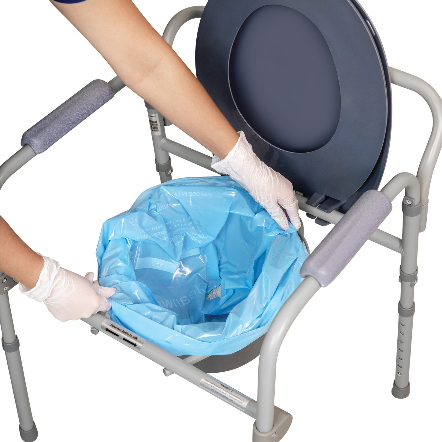 A person in gloves places a blue THE SANI-BAG+ Commode Liner onto a gray commode.