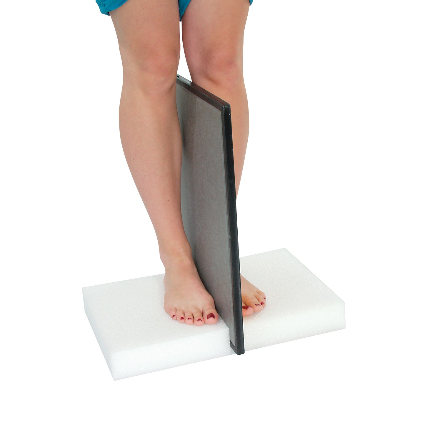 A person stands on an AliMed Weight-Bearing Cassette Holder. The holder is upright between their legs, on a white foam base.
