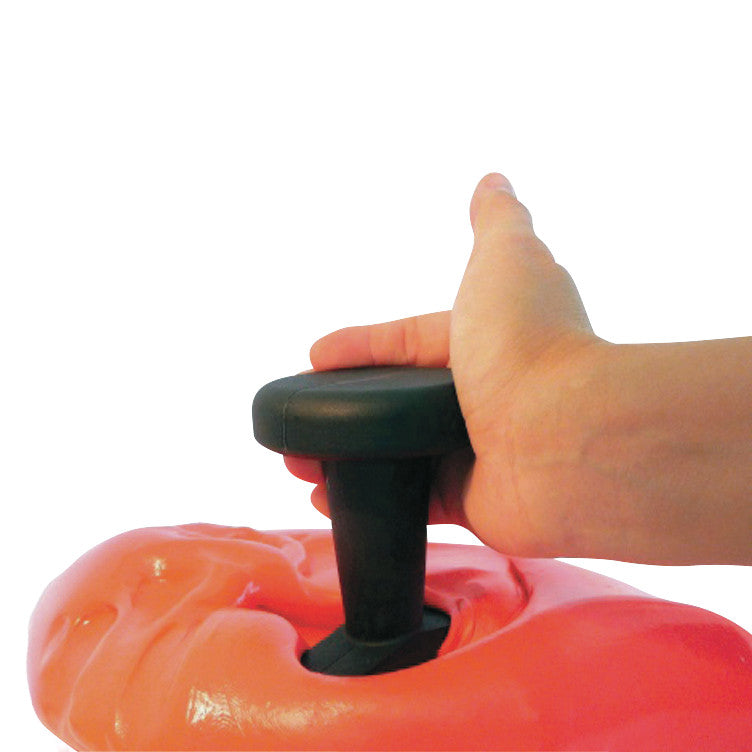 A hand uses the Puttycise Cap Turn Tool to press into a mass of orange putty, demonstrating a grip and twist action.