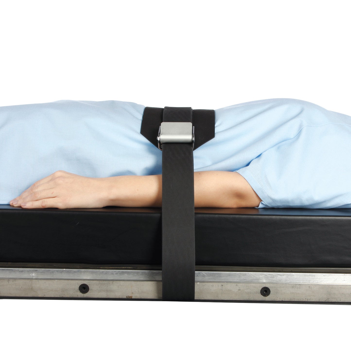 Person secured on a table with the AliMed Wipeable Operating Room Table Strap. The strap holds the person in place on a black surface.