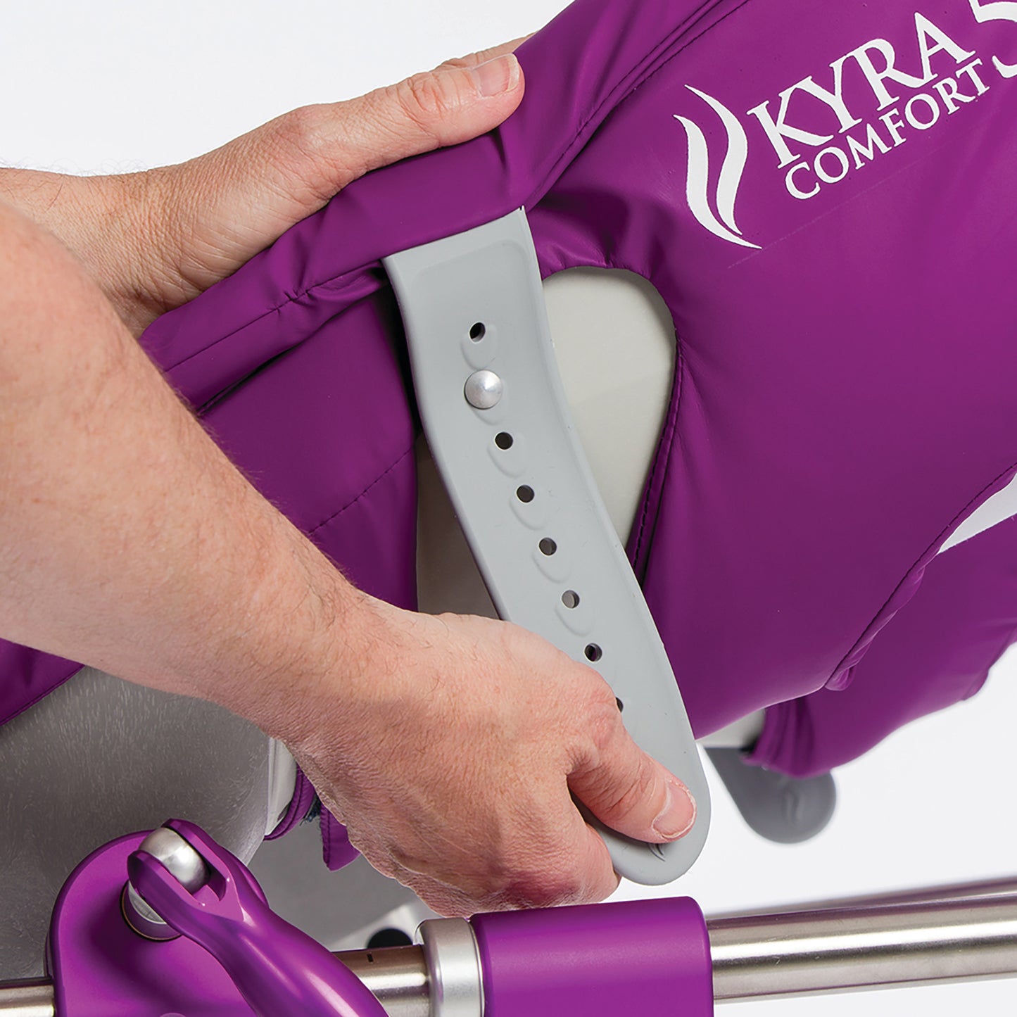 Hands adjusting a purple KYRA Comfort 350 Lithotomy Stirrup with Secure-Lok Straps, featuring an adjustable gray support.