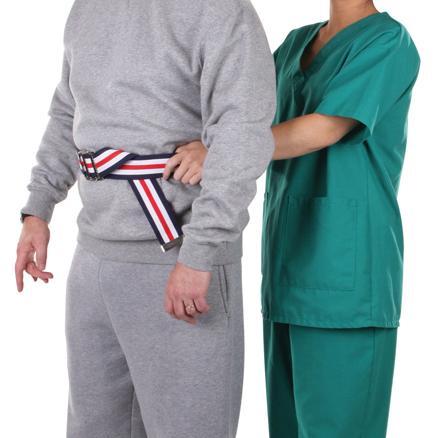 A person in gray sweats uses an AliMed Gait Belt, assisted by a person in green scrubs, for support and mobility training.