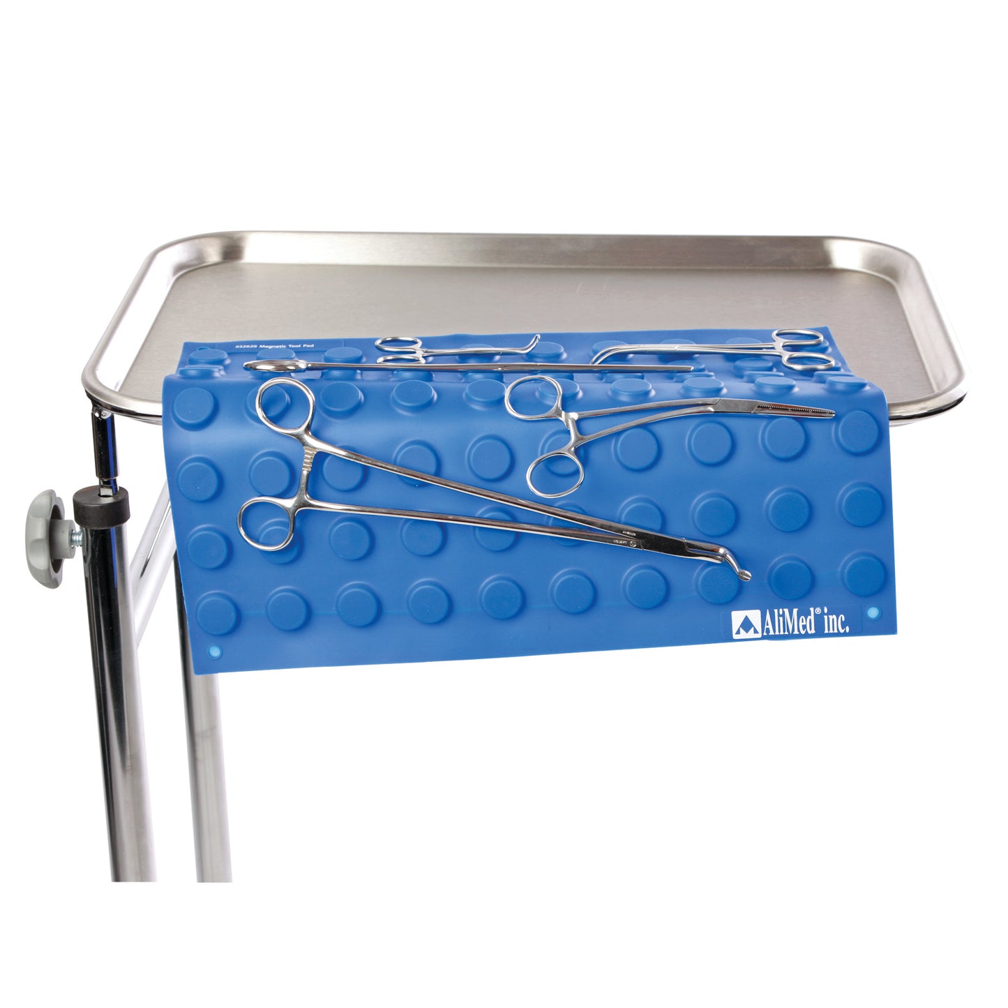 A blue AliMed Magnetic Instrument Pad on a metal tray holds surgical instruments securely with a textured, non-slip surface.