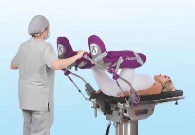 nurse putting patient in lithotomy stirrups