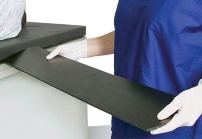 nurse putting armboard on operating table