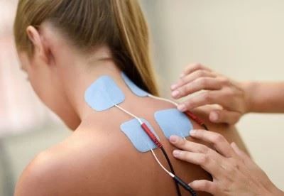 nurse putting electodes on patients back