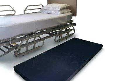 fall mat on floor next to bed