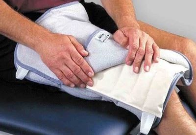 person using heating pad on leg
