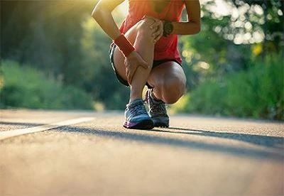 person holding leg after walk