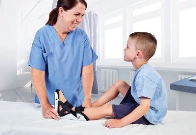 nurse putting brace on pediatric patient