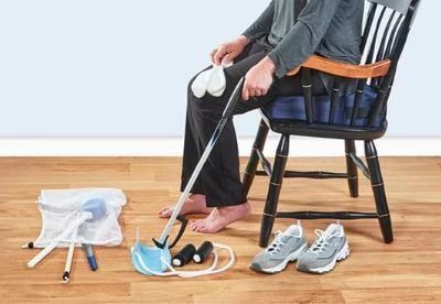 person using reacher to pick up face mask