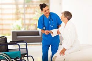 nurse helping patient out of bed