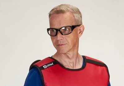 man wearing raidation apron and radiation protection glasses