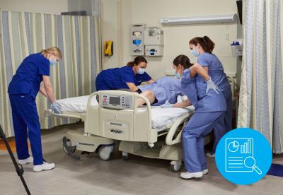 nurses transferring patient from hospital bed