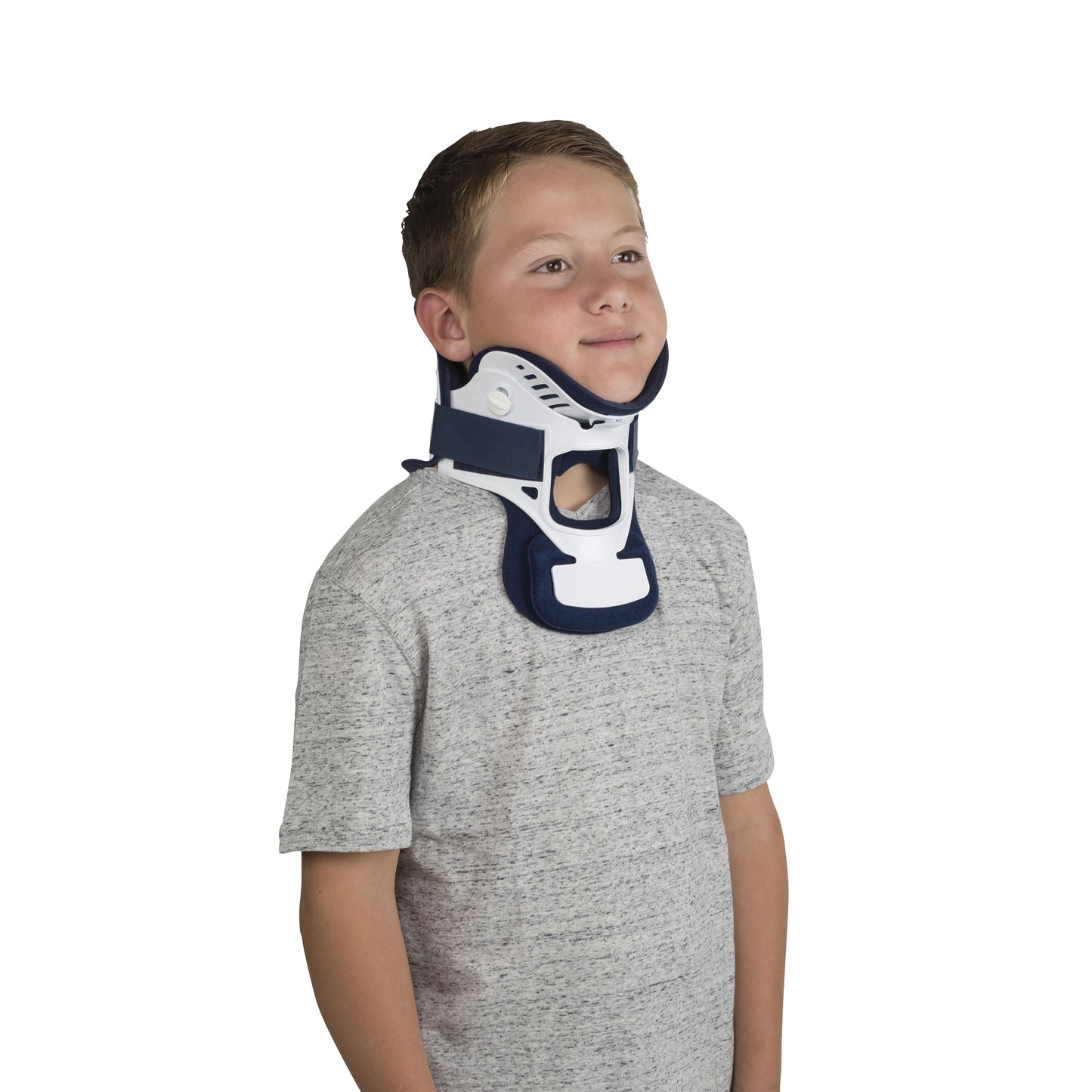 A boy wears a Miami Jr. Cervical Collar, providing neck support. He is in a gray shirt against a white background.