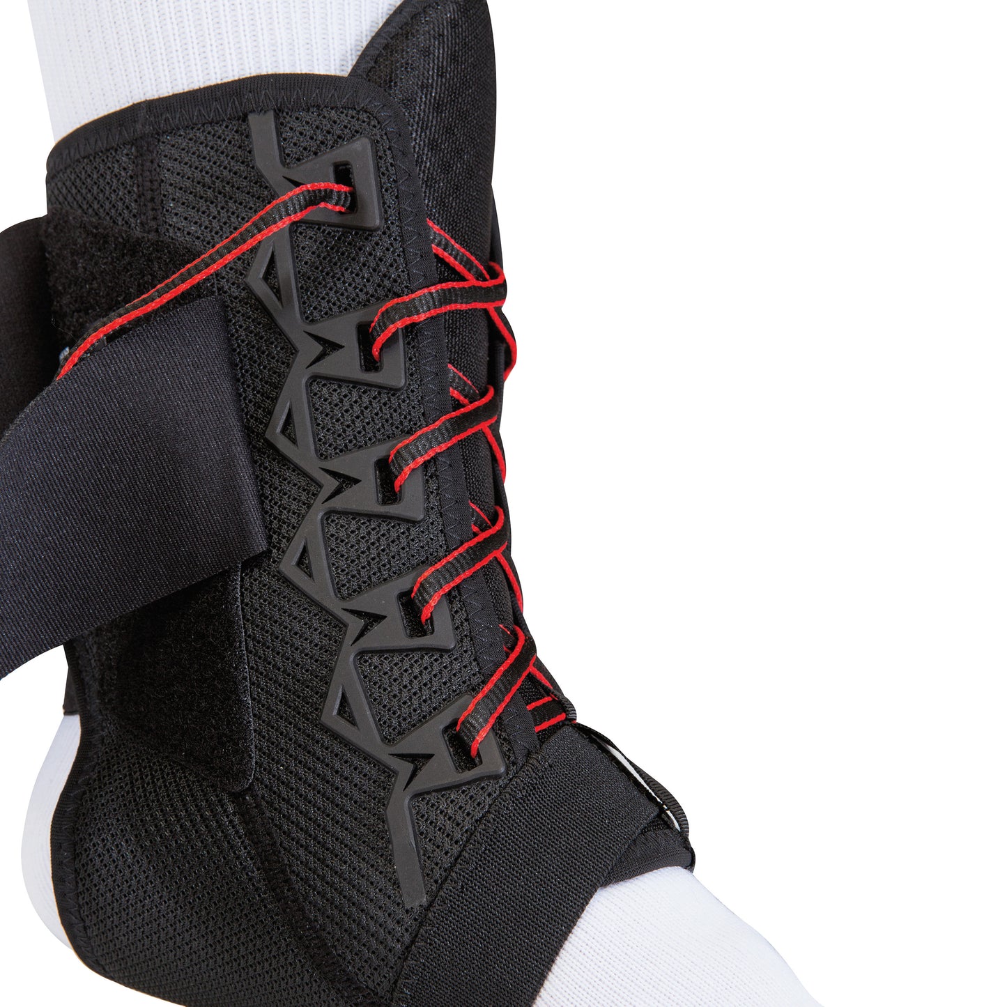 Mueller The One Ankle Brace on a foot with red laces, black support straps, and a geometric design over a white sock.