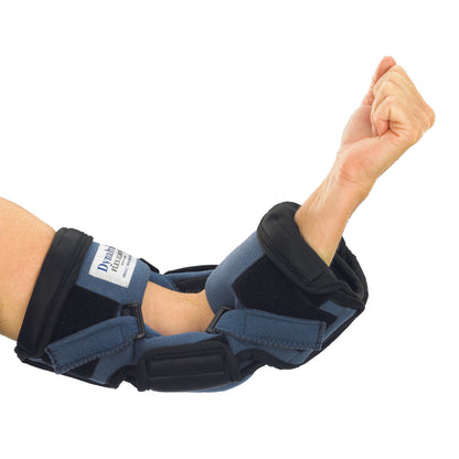 A person's arm is fitted with an OCSI DynaPro Flex Elbow Orthosis, featuring adjustable straps and padding for elbow support.