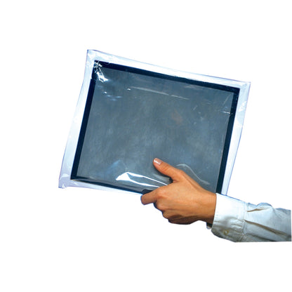 A hand holds a Protex-Ray Clear Film Disposable Cassette Cover, showing its transparent protective sleeve with a black border inside.
