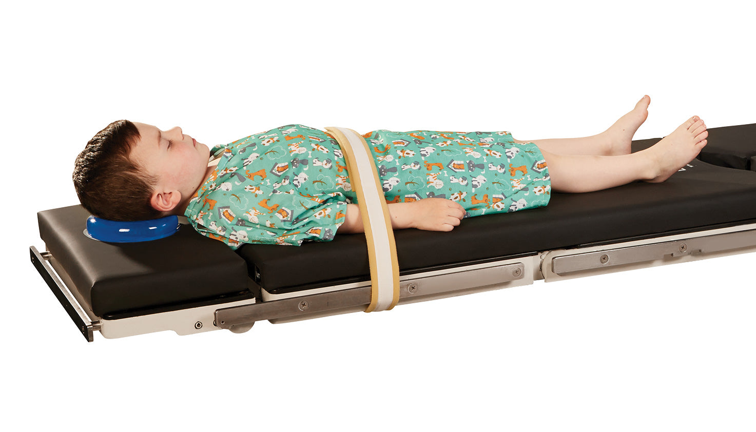 pediatric patient on operating table with patient safety strap and positioner