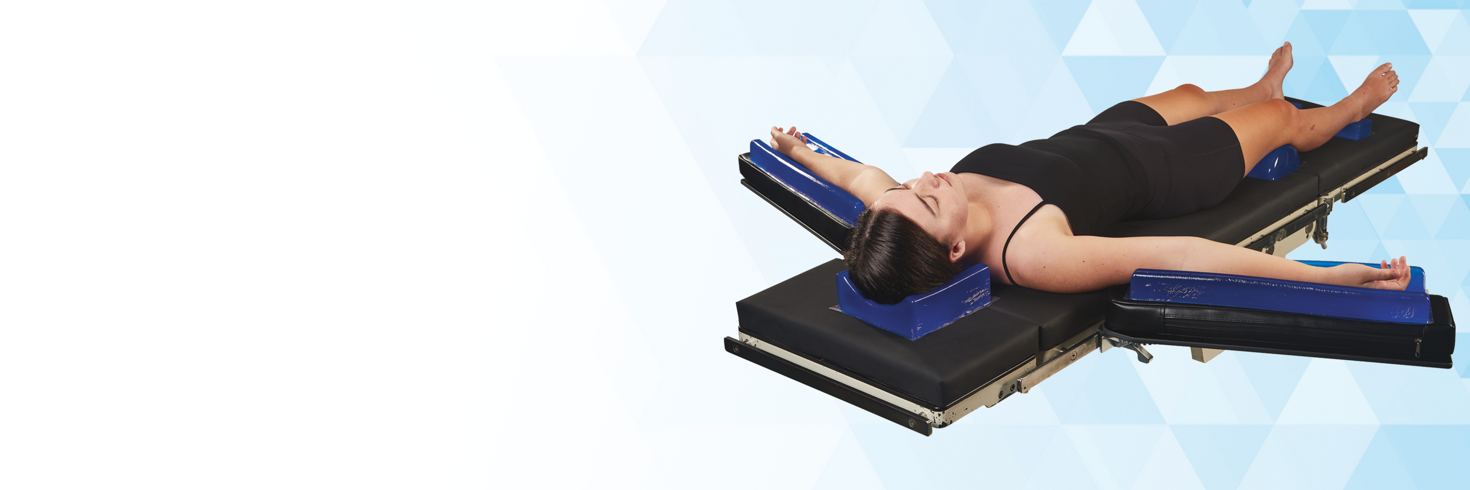 Person lying on an Operating Room table with AliBlue Gel positioners against a white background