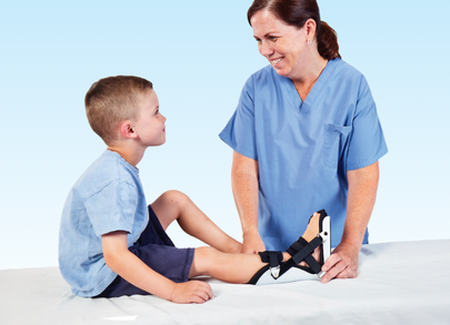 nurse putting pediatric brace on patient