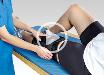 nurse putting knee brace on patient with video icon
